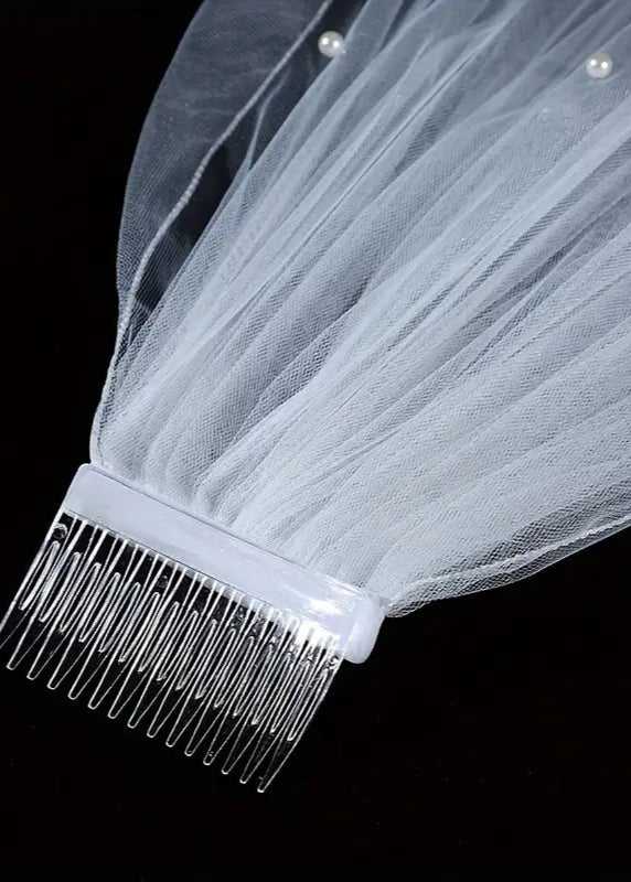 veil with a comb on a black background